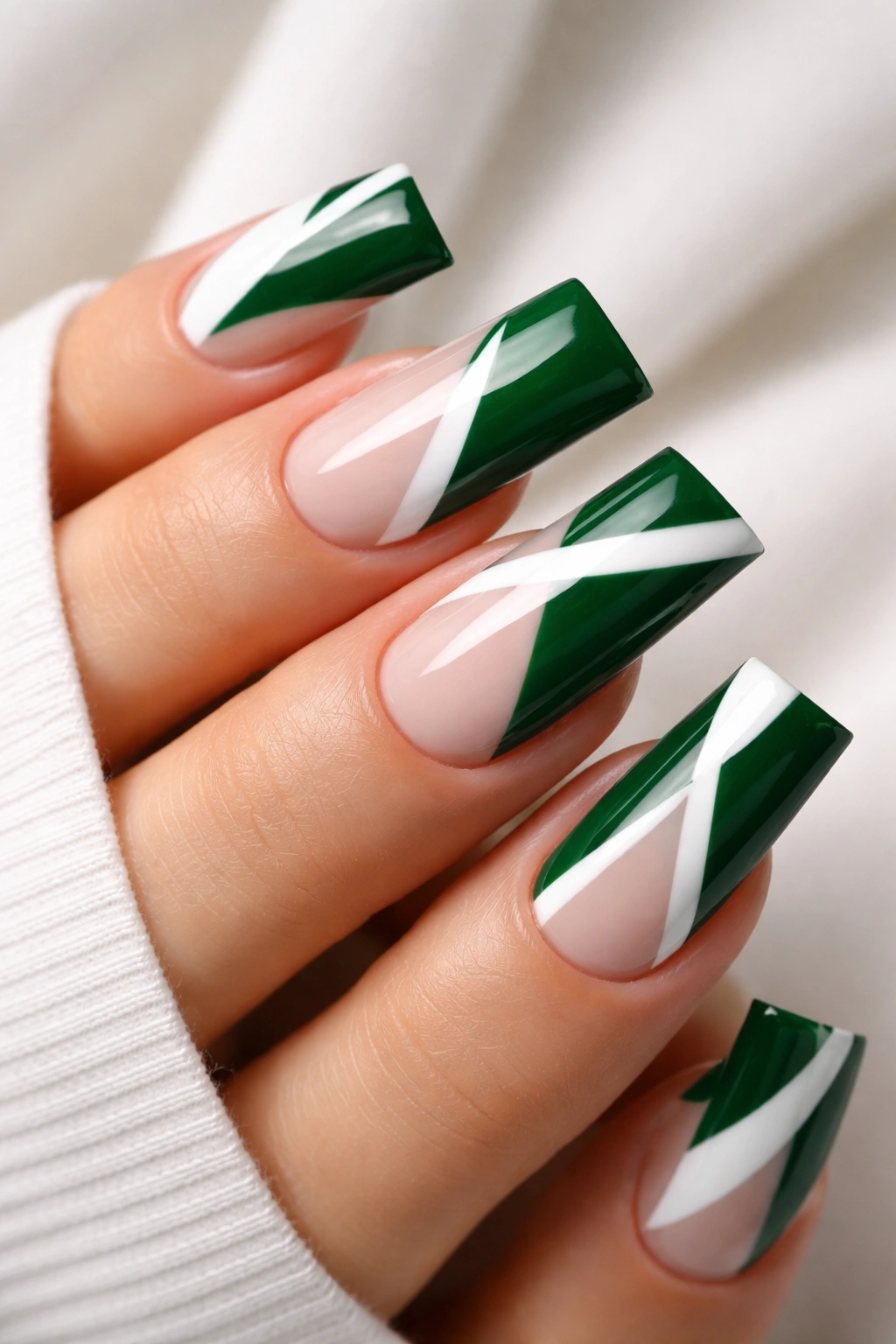 Close-up of green and white geometric duck nails on a neutral background
