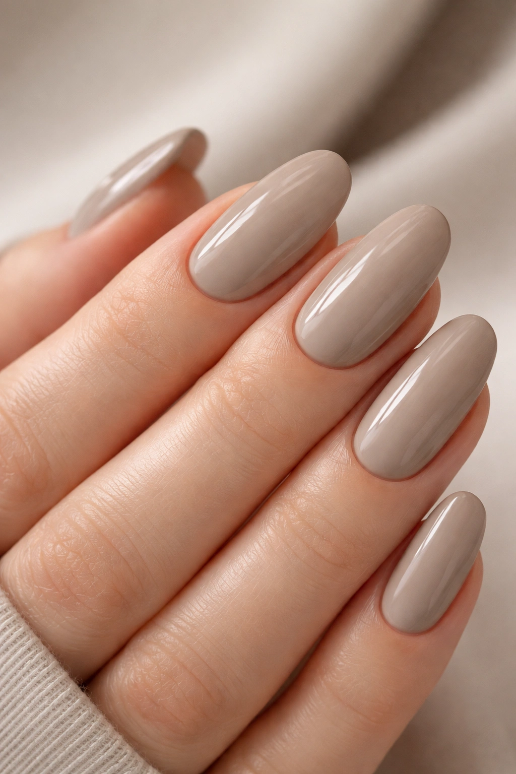 Close-up of hands with Greige nails in balanced gray-beige polish