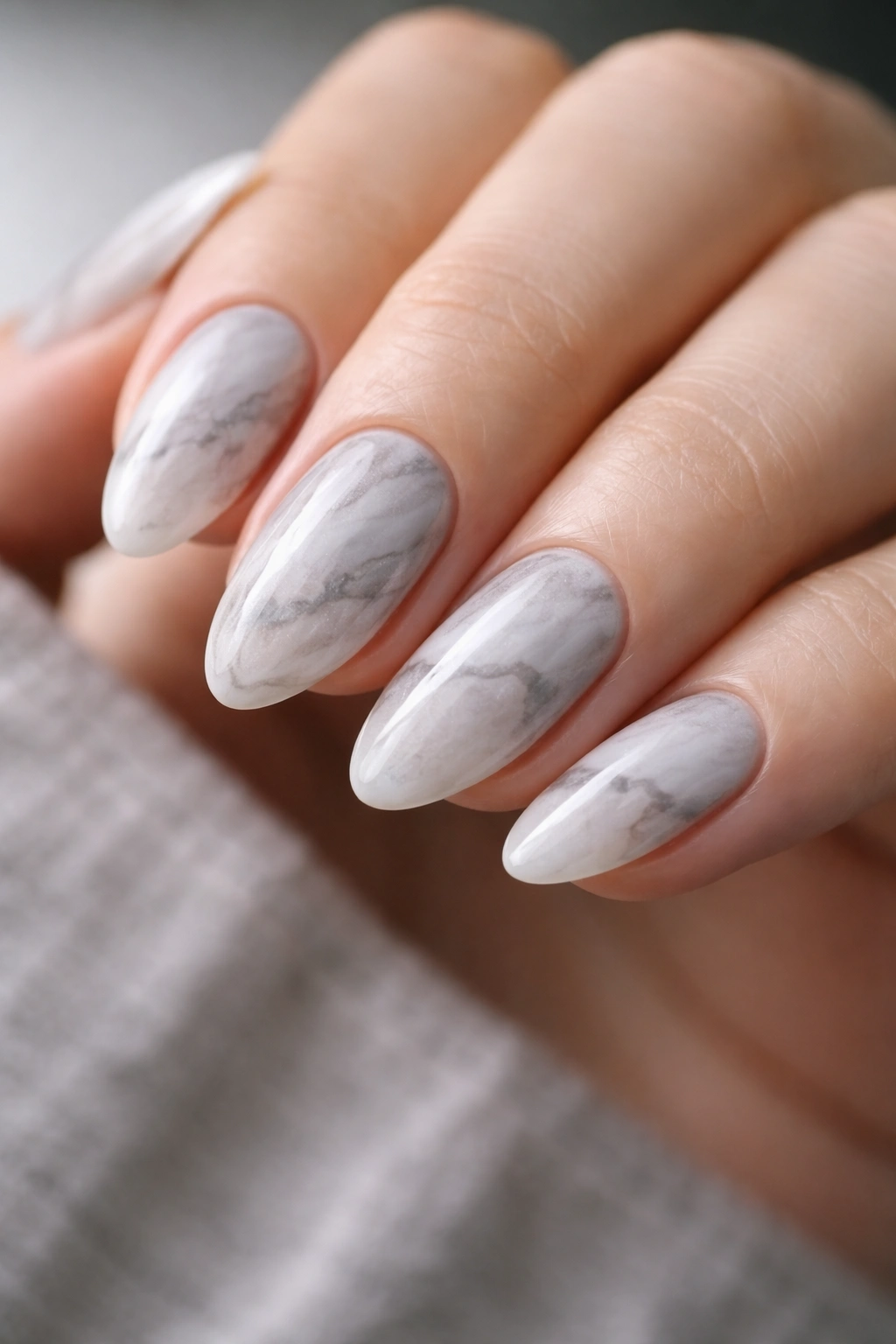 Short almond nails with grey and white marble pattern