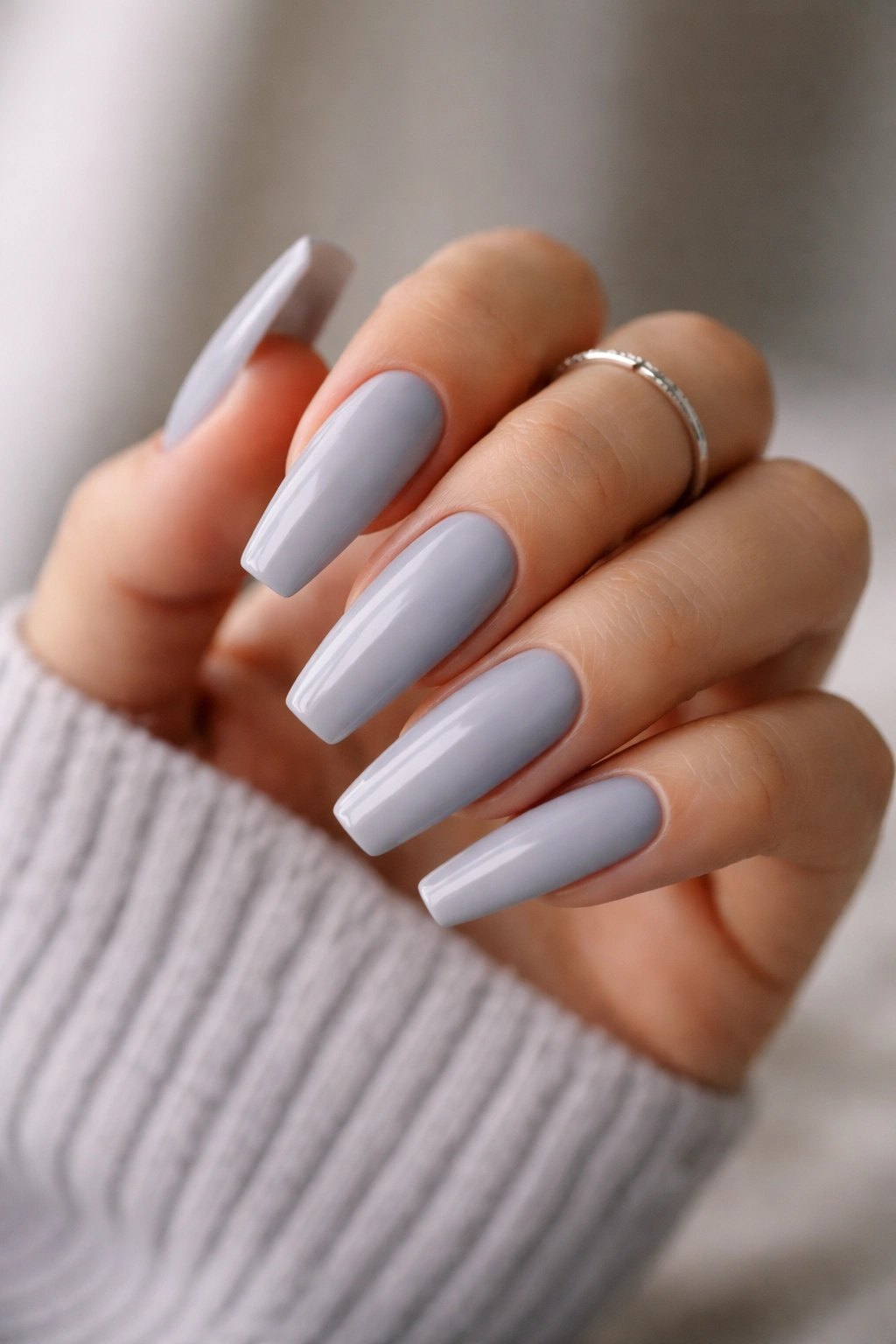 Close-up of long grey ballerina nails with blunt tips and glossy finish