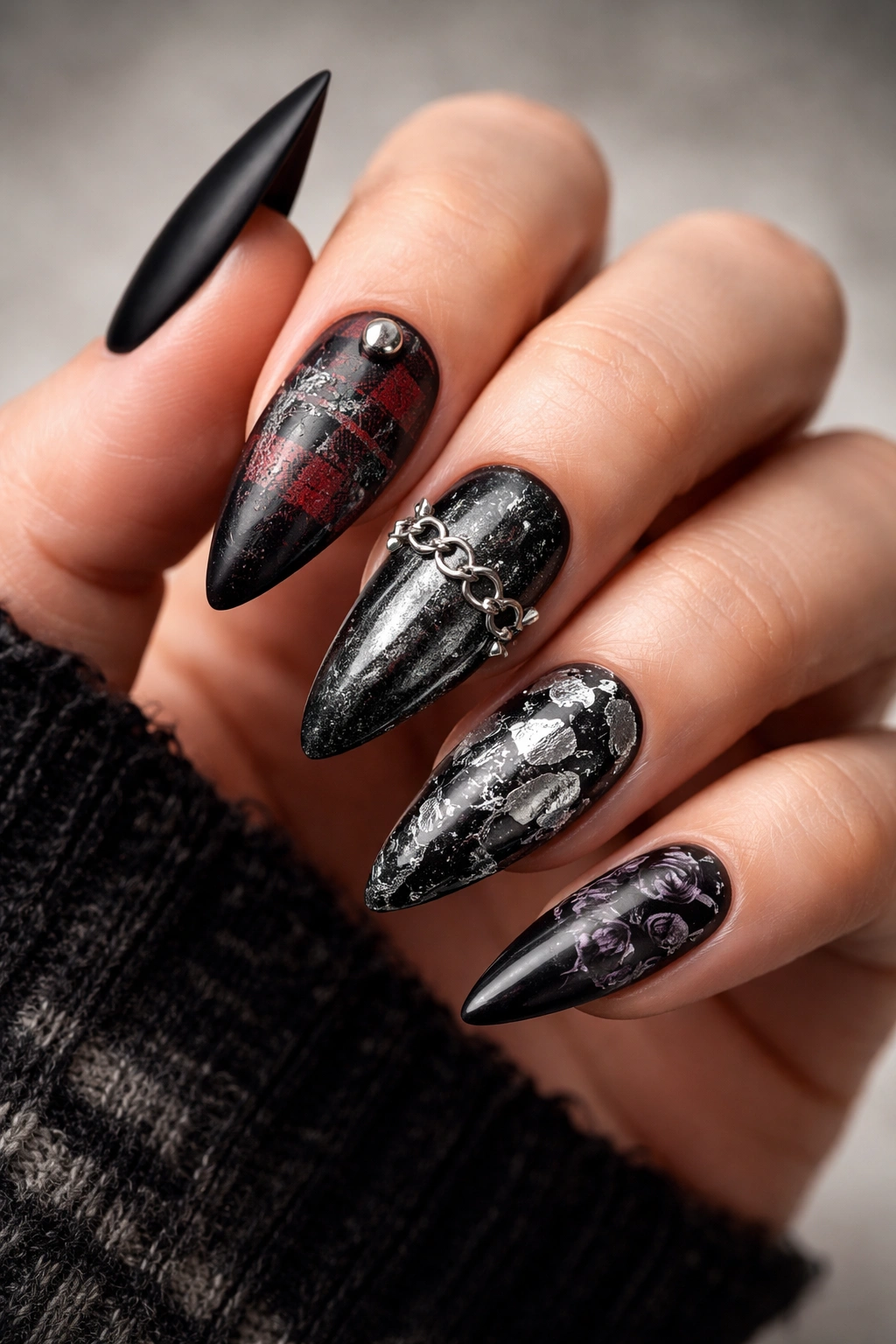 Close-up of nails showing a progression of grunge nail designs.