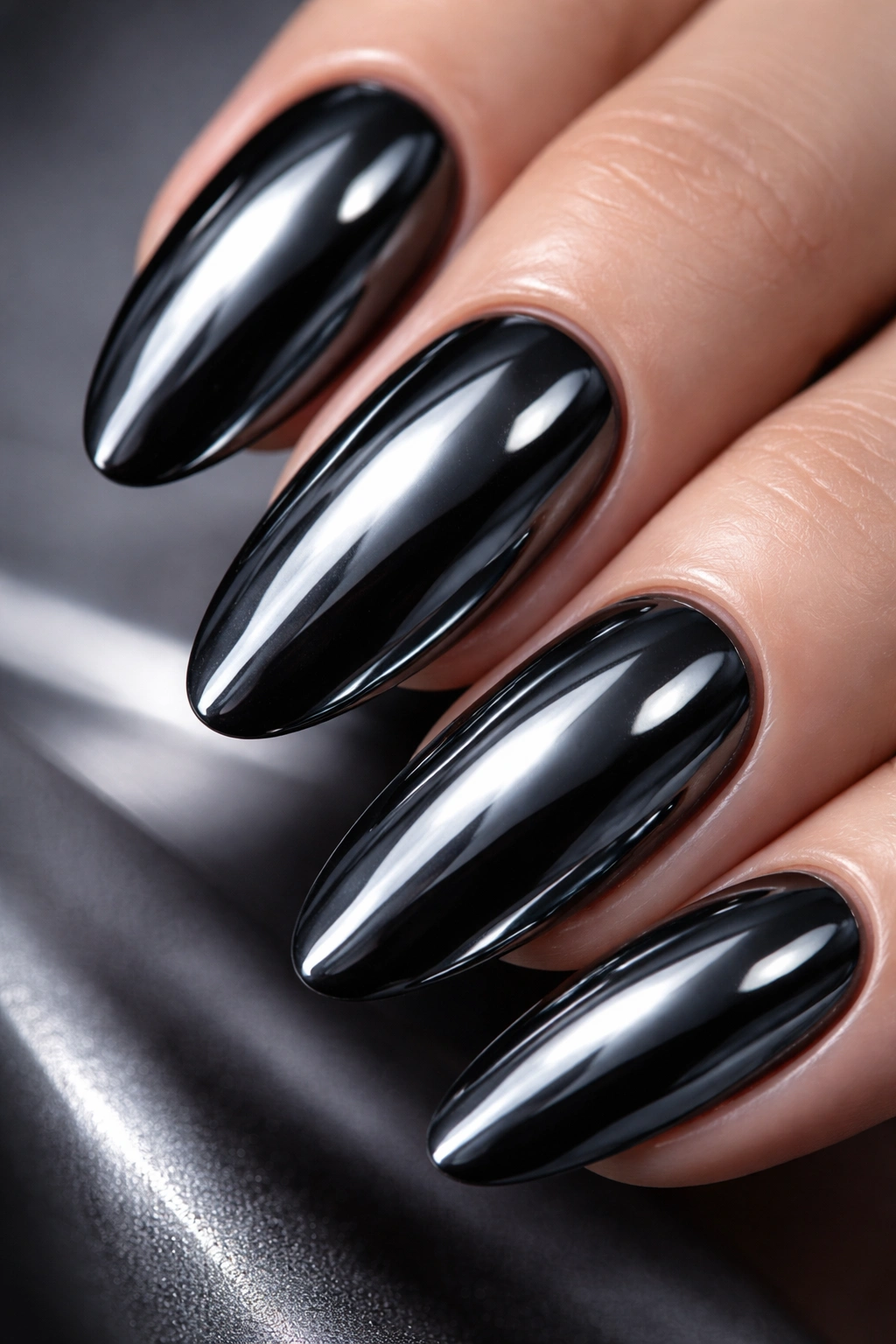 Close-up of gunmetal gray chrome nail with mirror-like finish