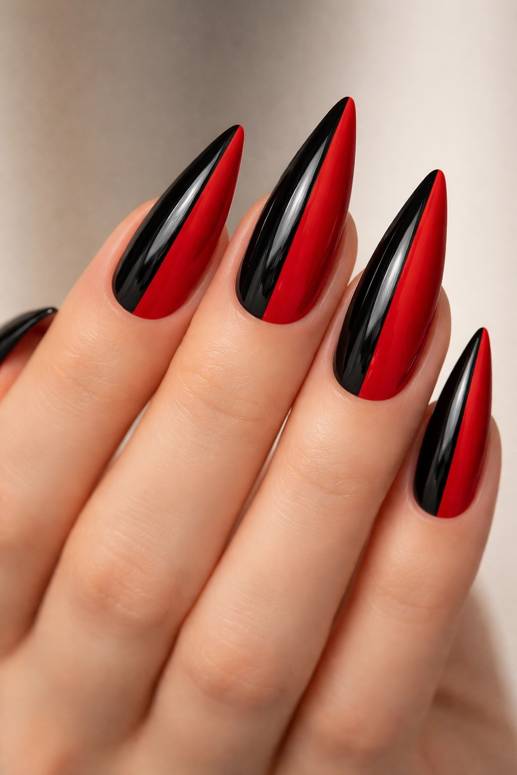 Close-up of stiletto nails with black and red vertical split