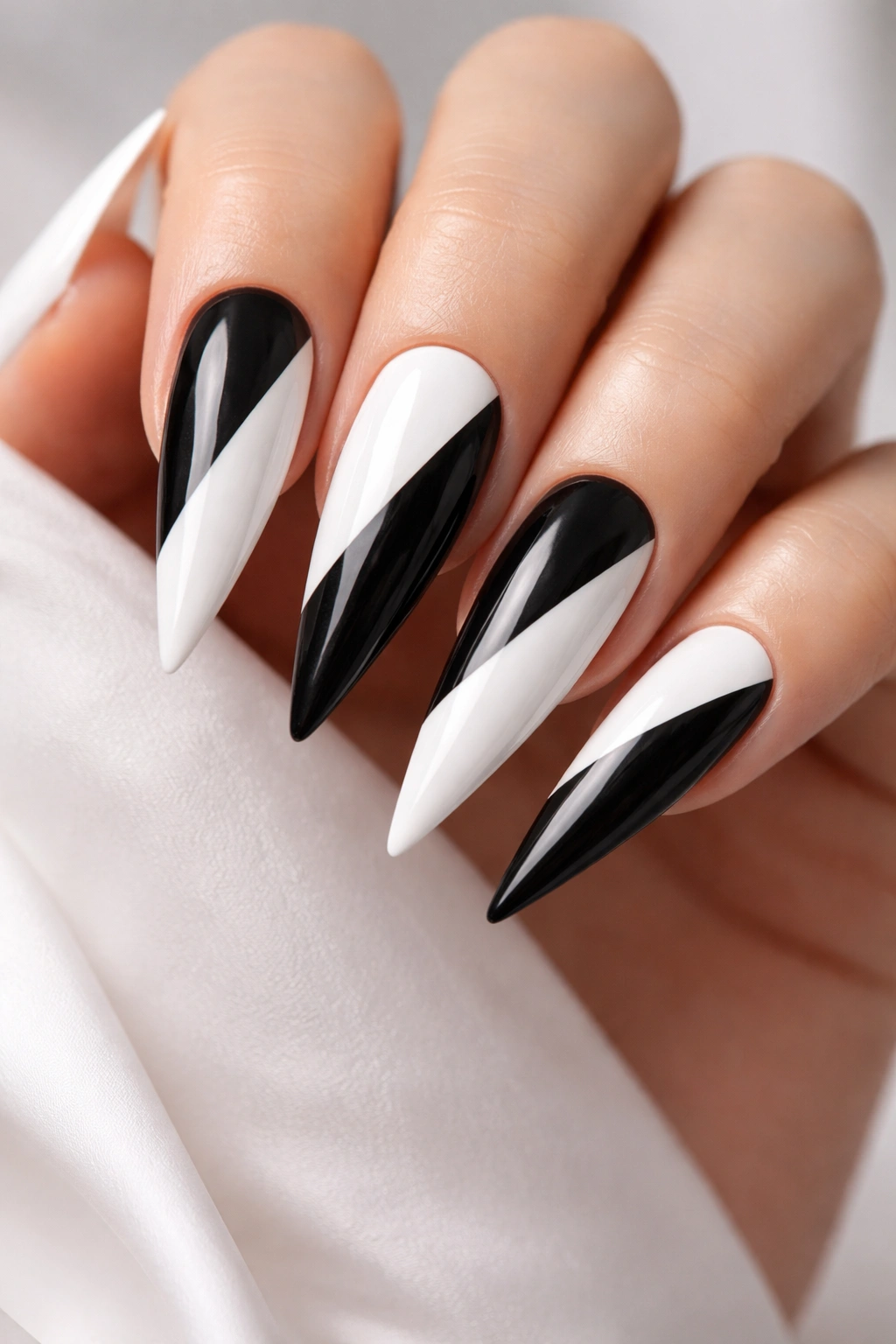Stiletto nails with black and white half-and-half diagonal split