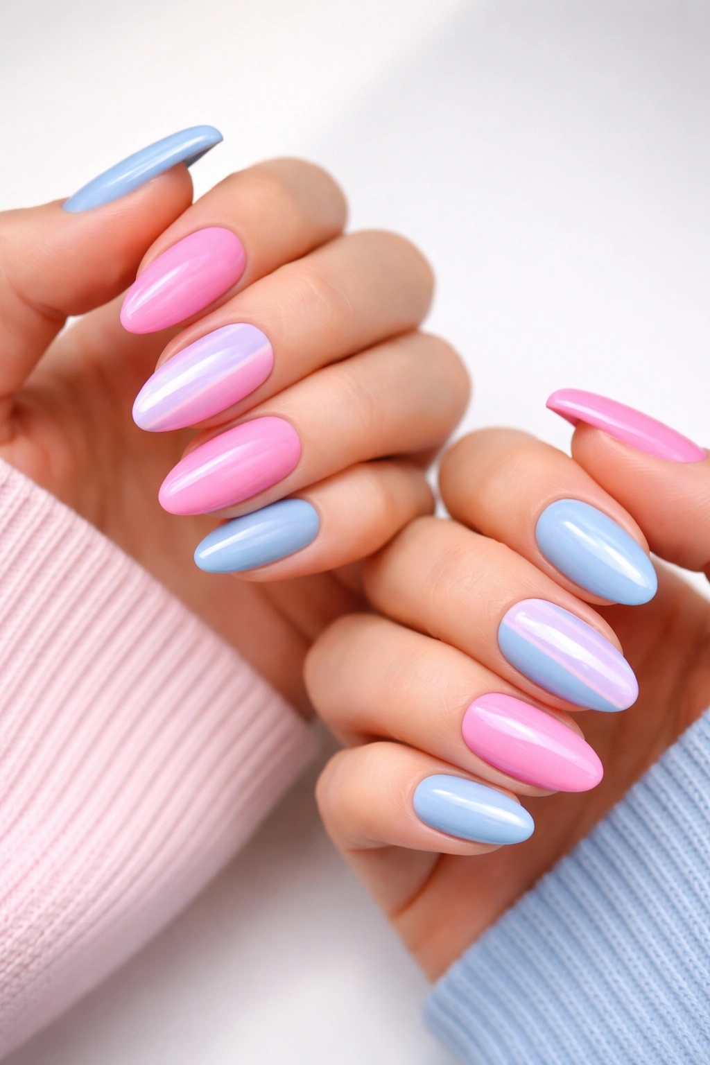 Close-up of half-and-half split nails on both hands in bold two-tone colors