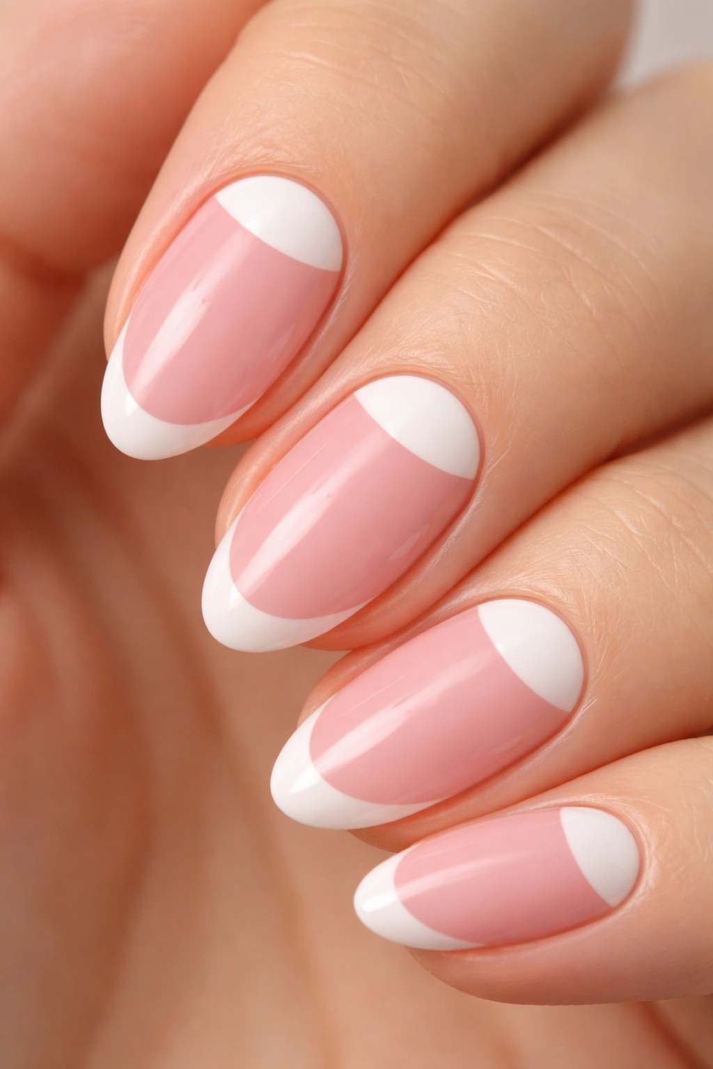 Close-up of a short almond nail with a white half-moon at the cuticle.