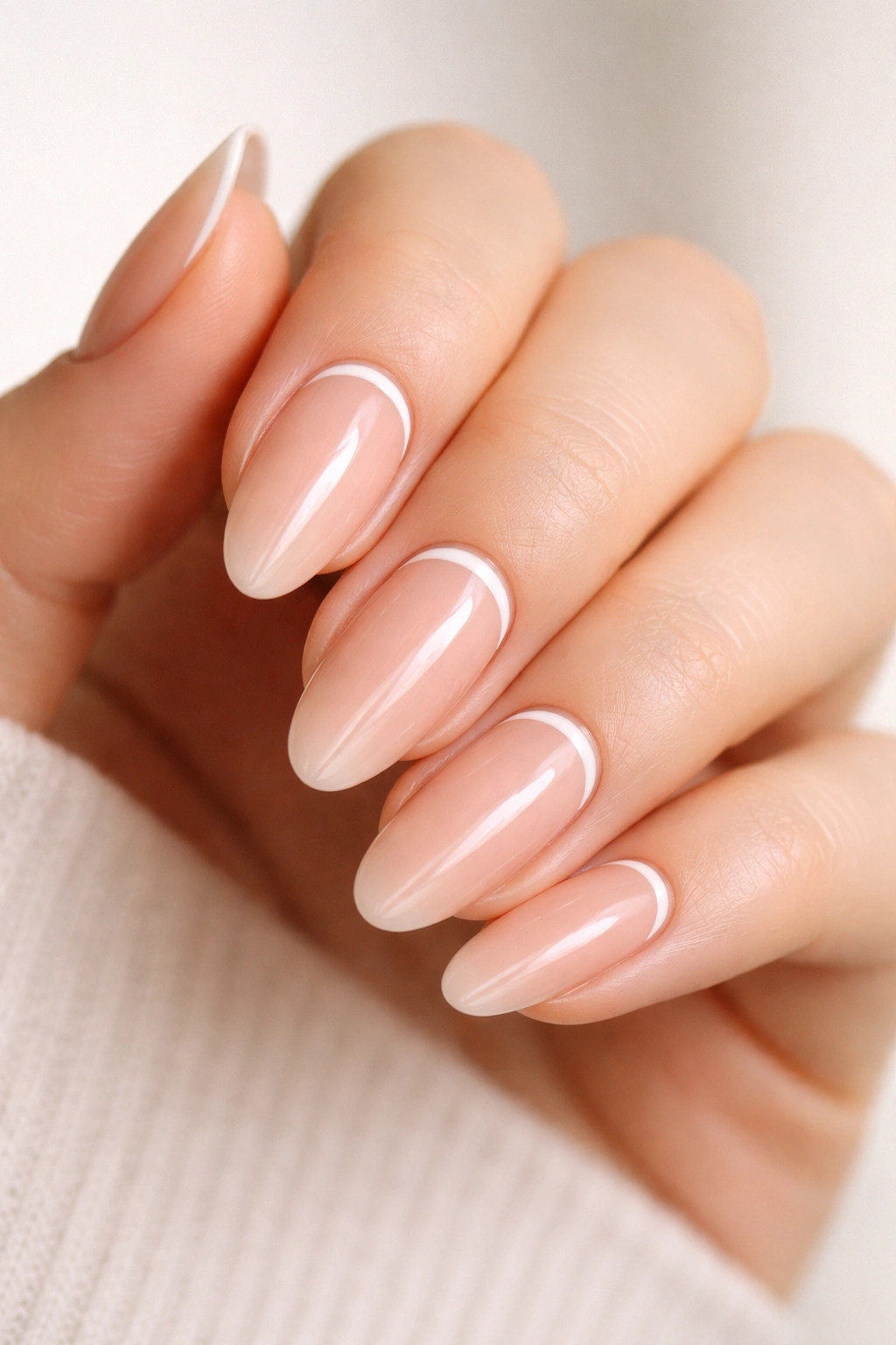 Nude long-oval nails with a white half-moon near the cuticle