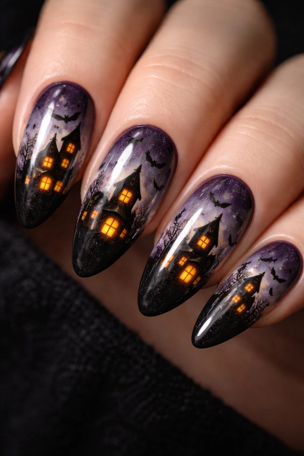 Almond nails with haunted house silhouette and glowing windows