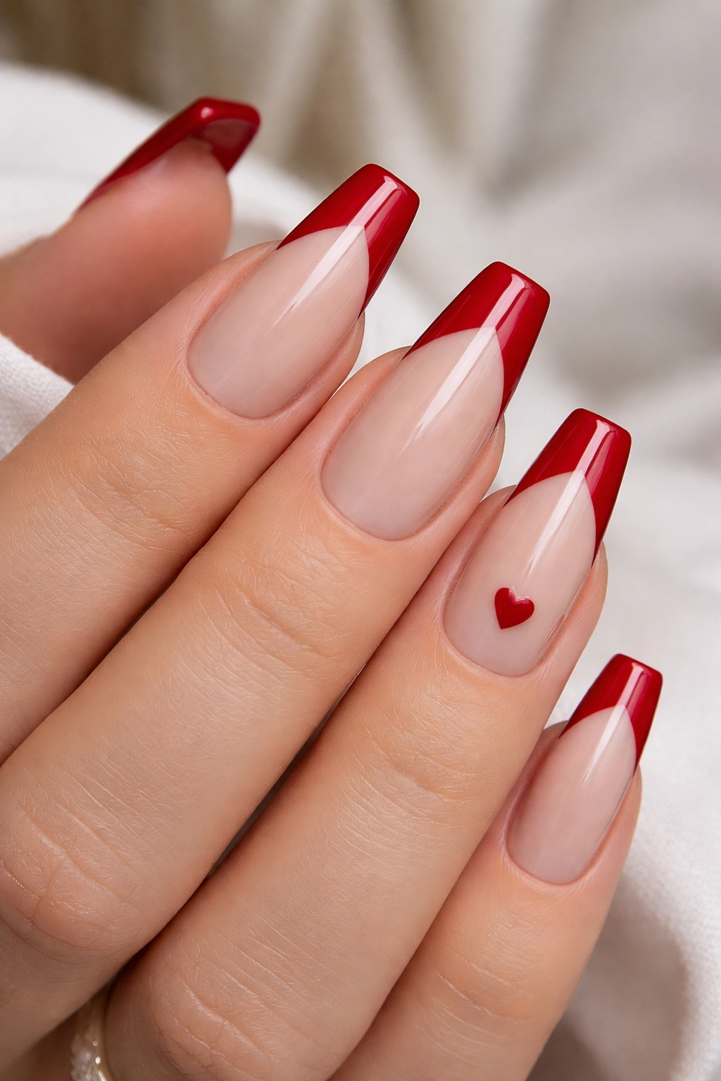 Nail set with small negative-space heart cutout on one accent nail