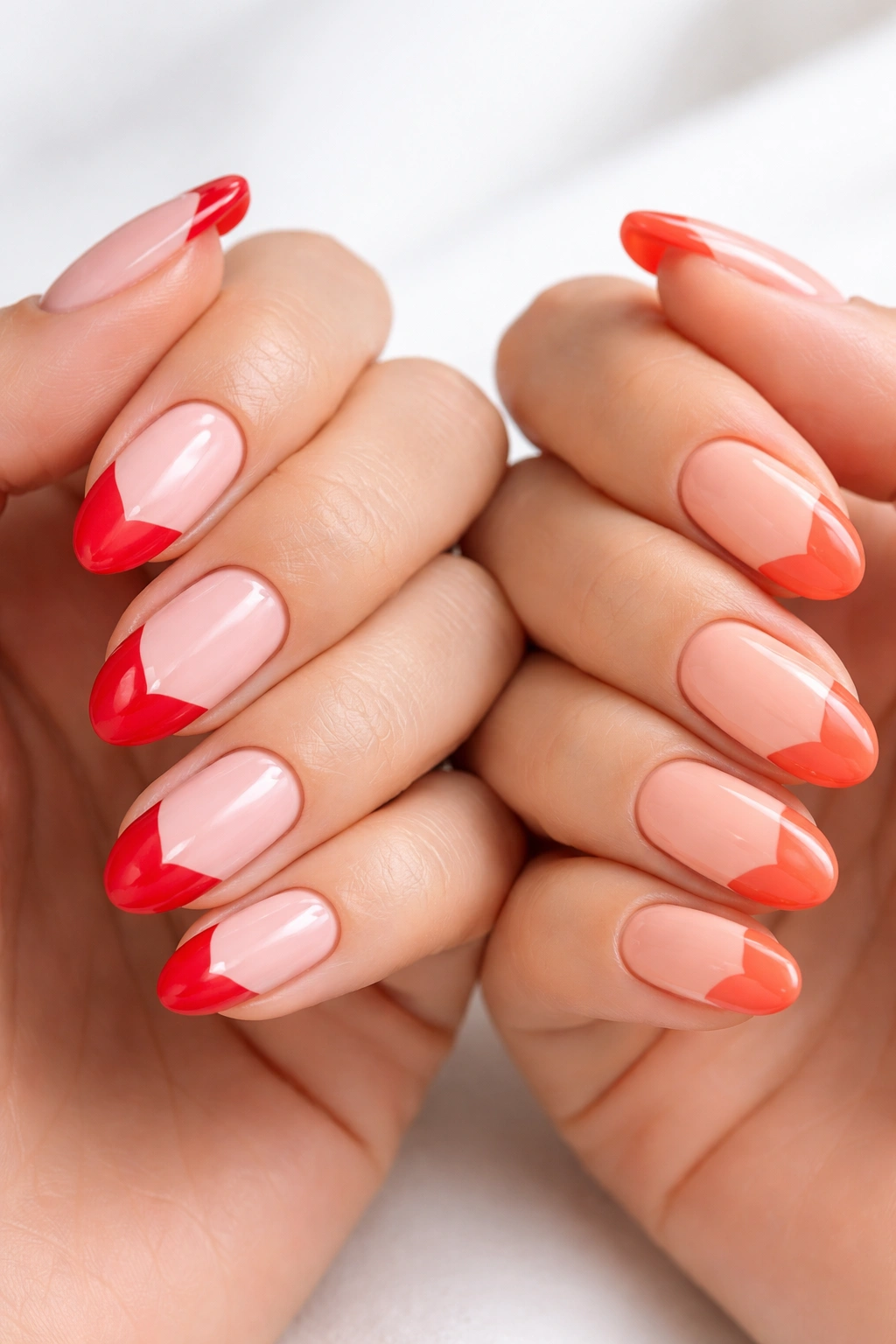 Close-up of nails with heart-shaped tips in pink and peach bases