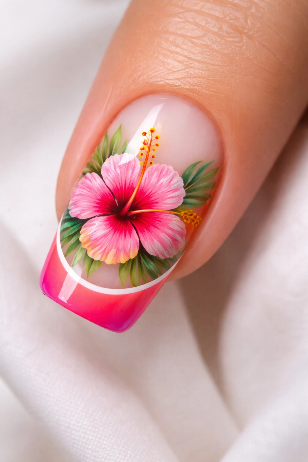 Close-up of a nail with hibiscus accents on a colored French tip
