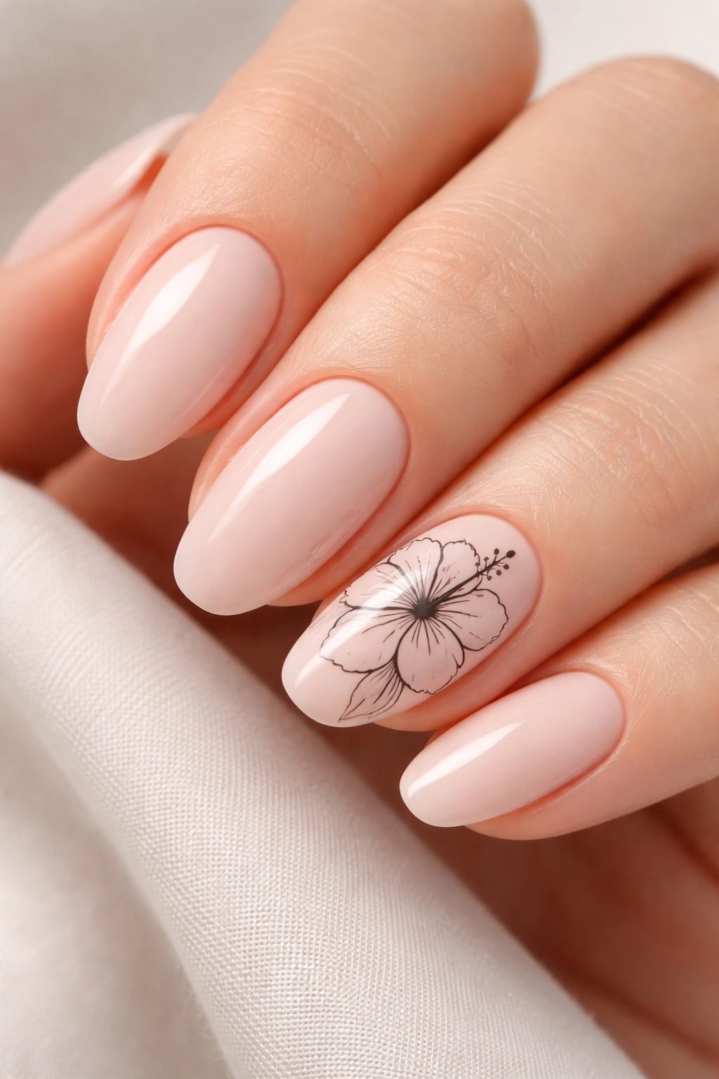 Close-up of nude nail with black hibiscus line art