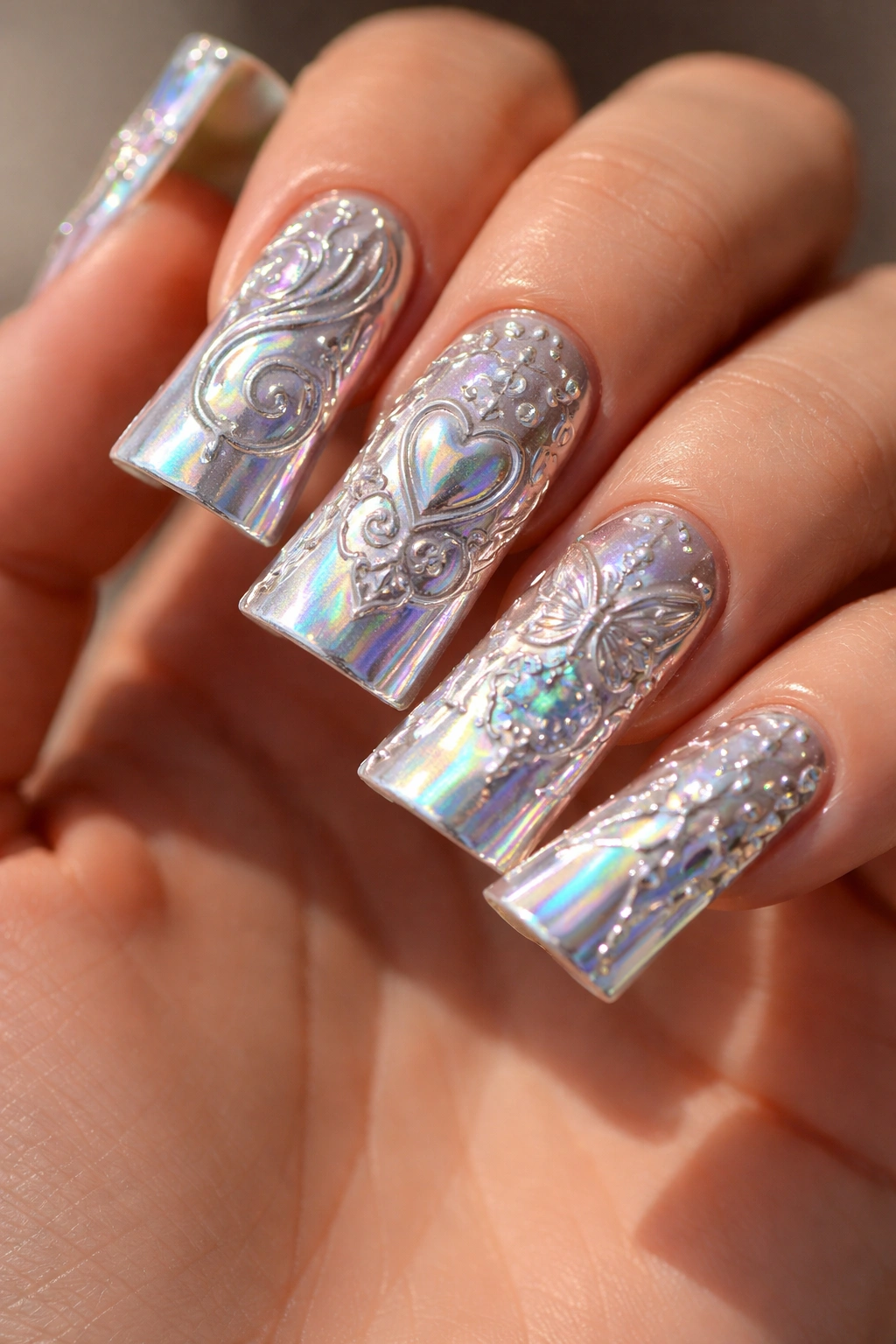 Holographic chrome nails with raised stamping patterns