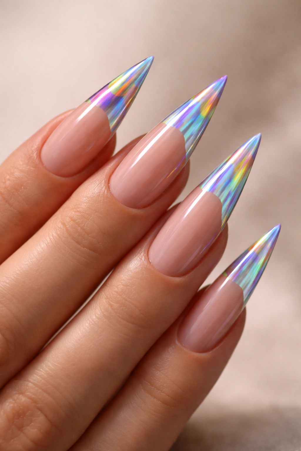Close-up of holographic rainbow-tip stiletto nails