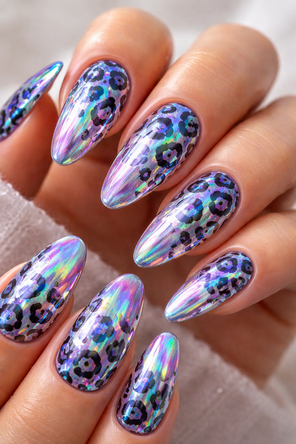 Close-up of holographic leopard print nails with shifting iridescent colors