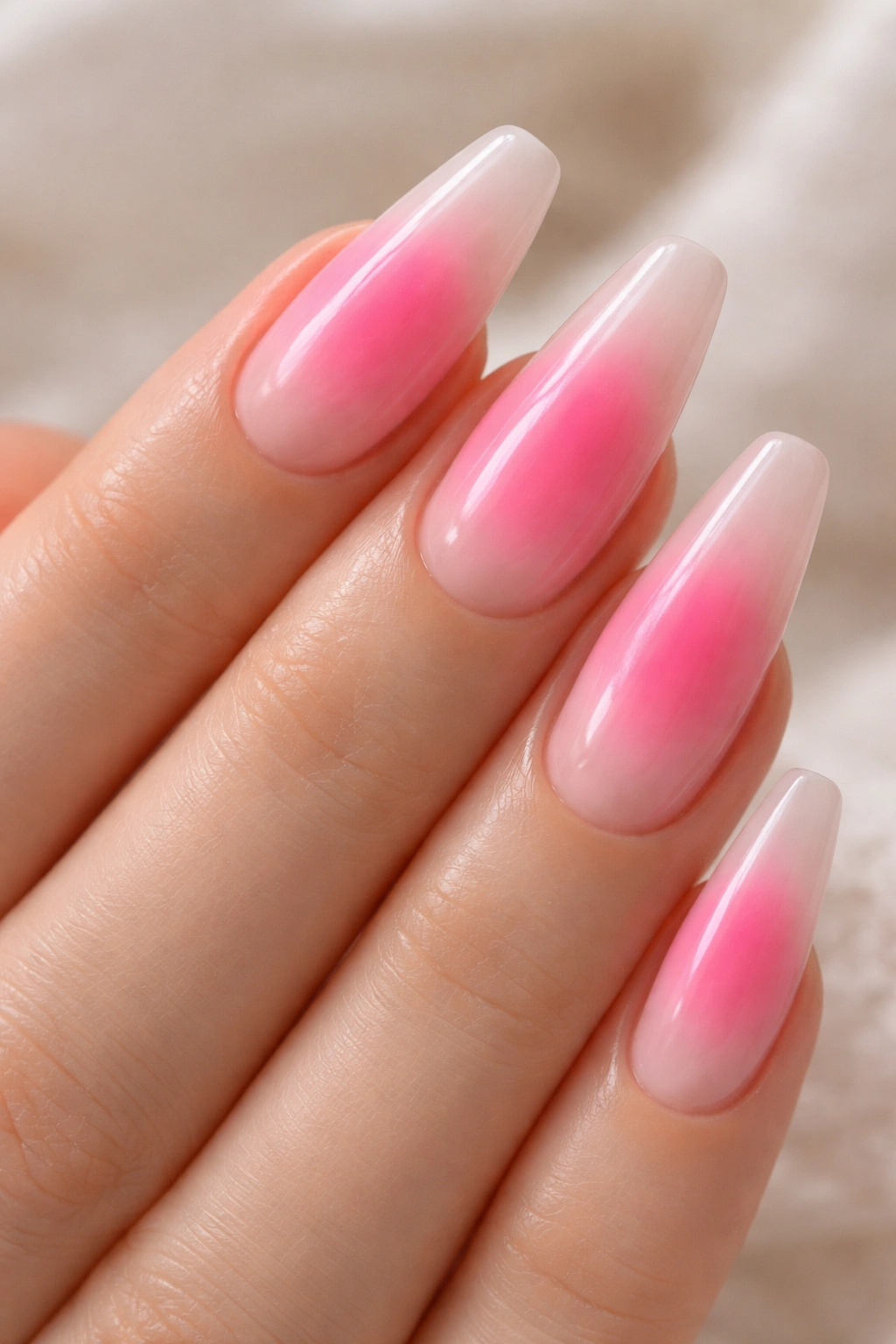 Close-up of hot pink aura centered on sheer base nails