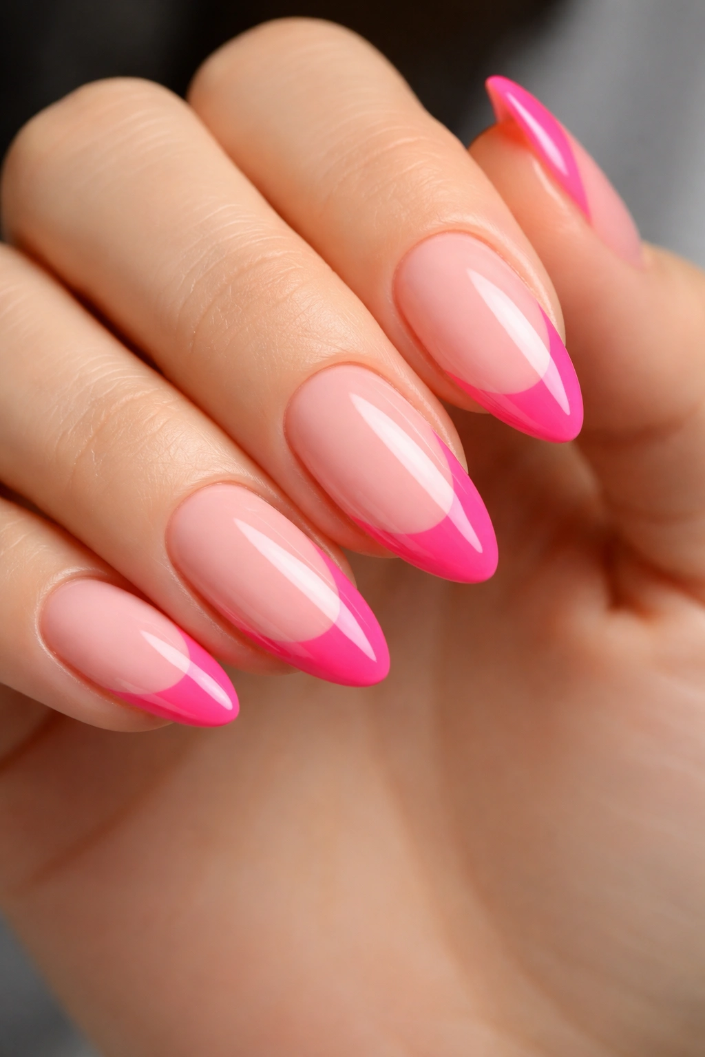 Close-up of hot pink French tip nails on nude base