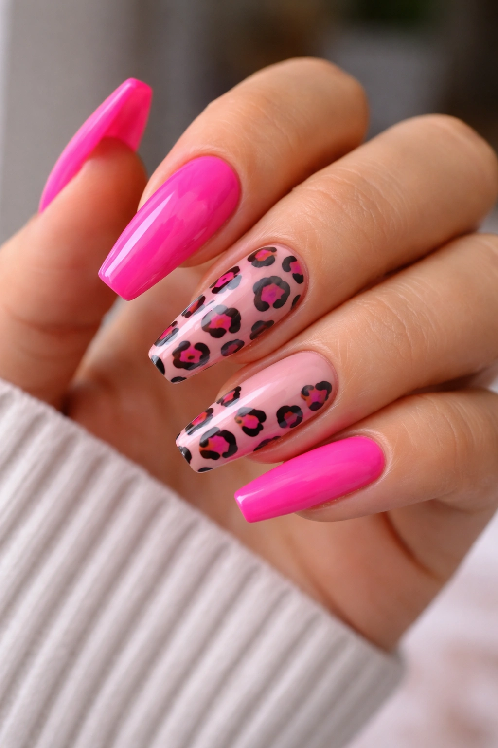 Close-up of nails with hot pink and leopard accents on mixed nails
