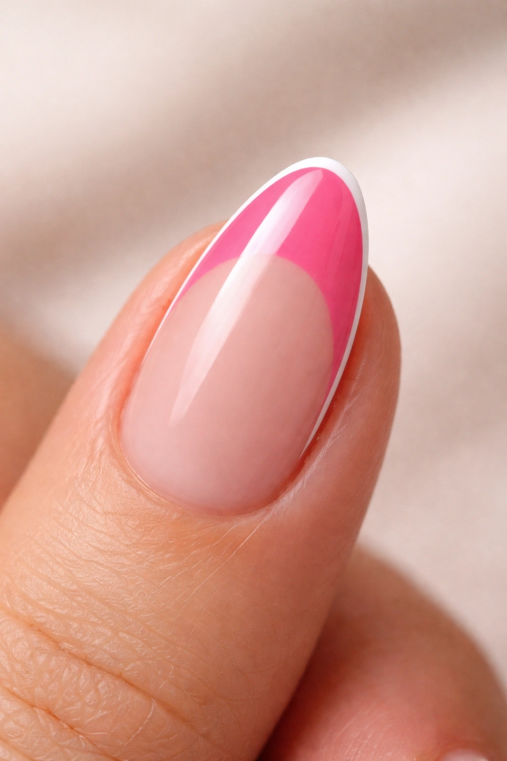 Close-up of a short almond nail with hot pink tip and white micro outline along the smile line