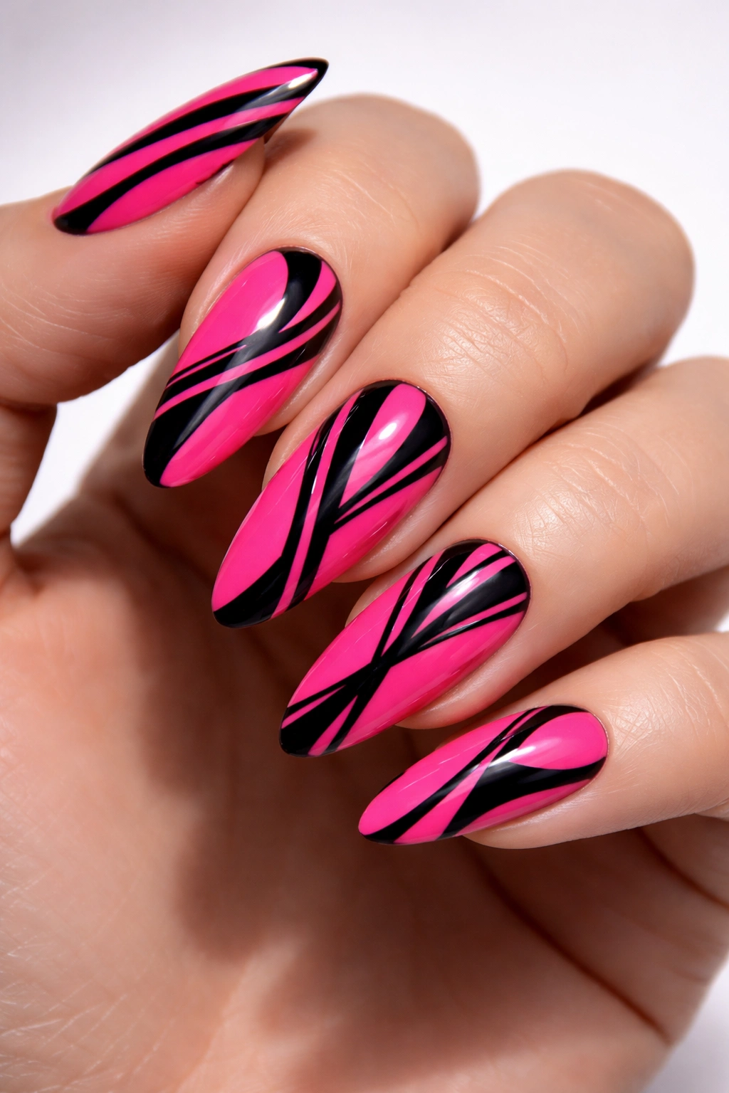 Close-up of hot pink nails with black graphic lines