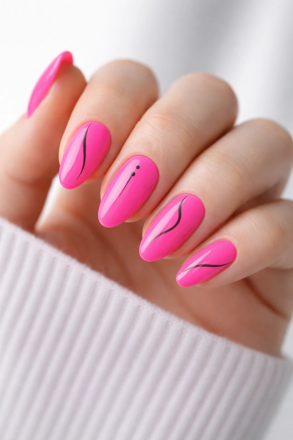 Hot pink almond nails with thin black line art on short nails