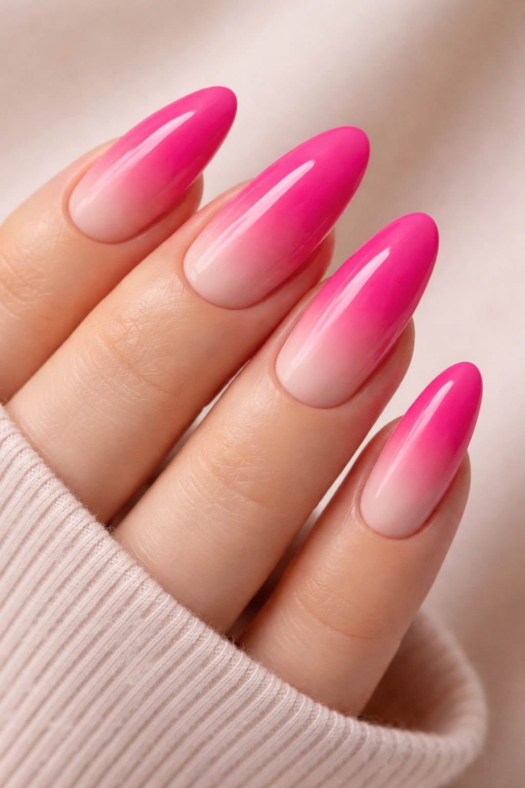 Long oval nails with hot pink to nude ombre tips.