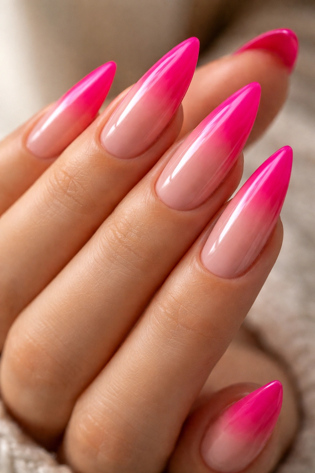 Close-up of hot pink nails with reverse ombré toward nude