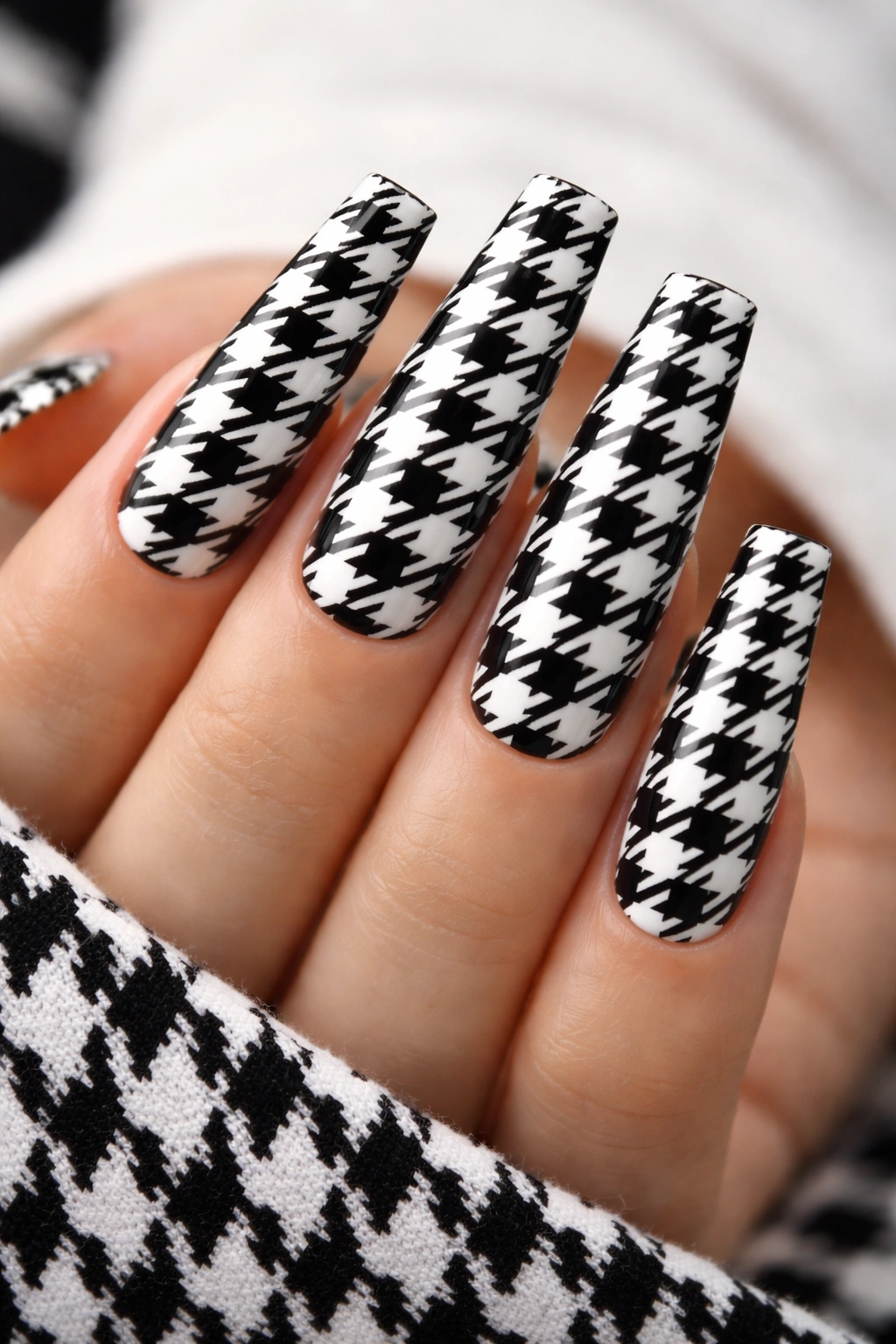 Close-up of coffin nails with classic black-and-white houndstooth pattern.