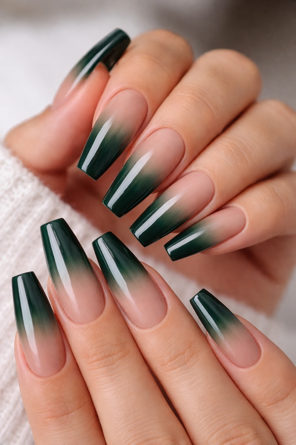 Close-up of hunter green ombré fade nails on a ballerina manicure