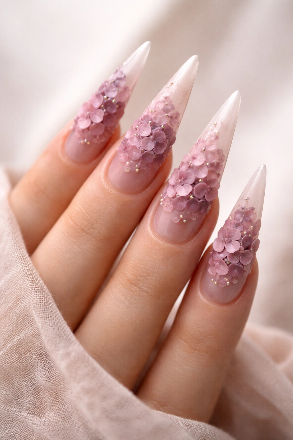 Blush translucent nails with raised hydrangea clusters in mauve and pink