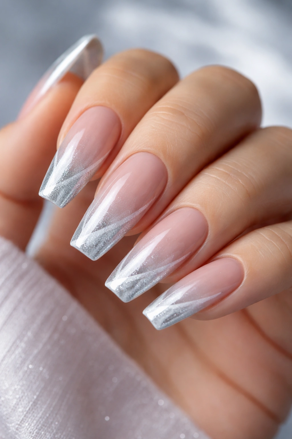 Ice silver French cat eye ballerina nails on a hand