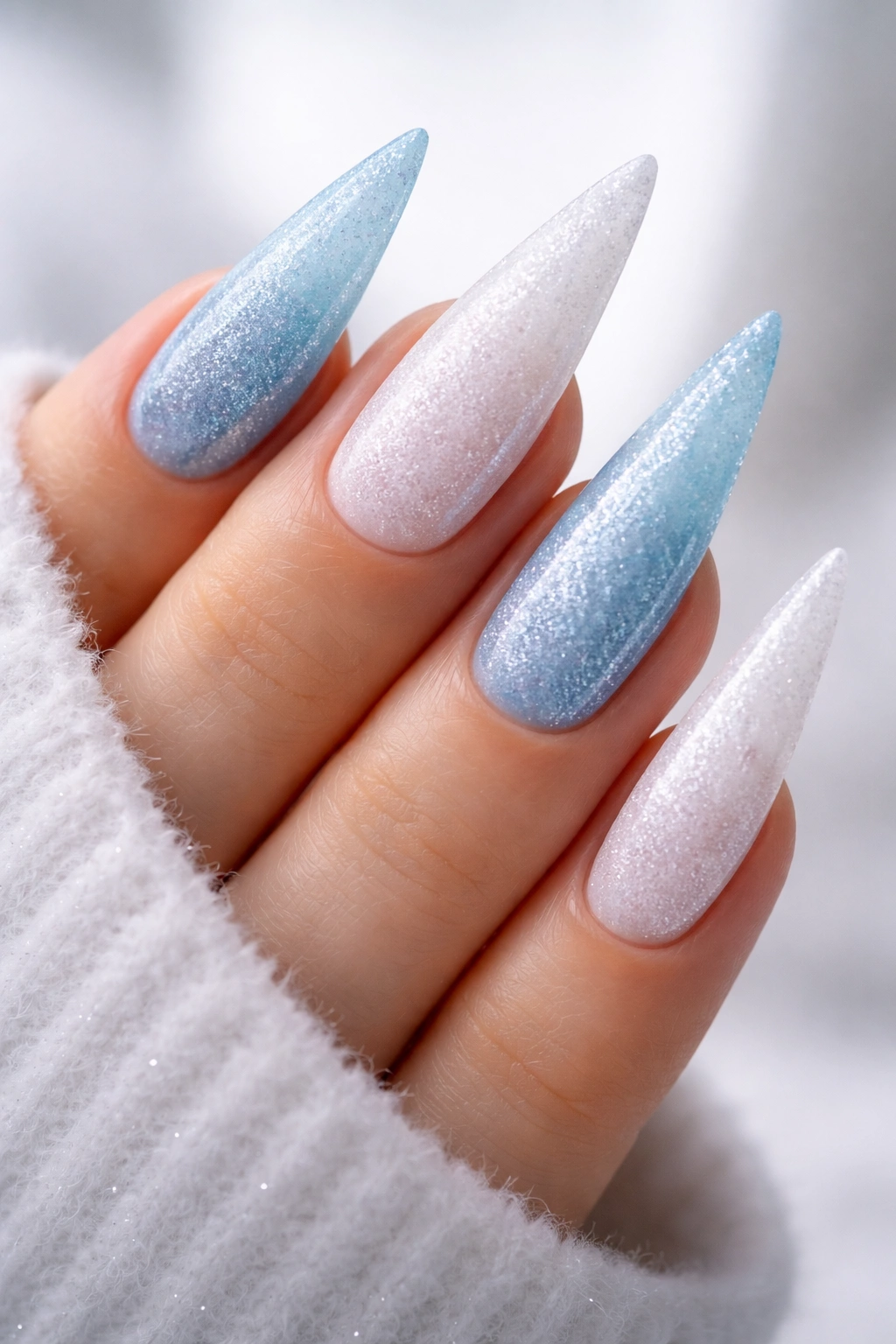 Close-up of Icy Blue and White Frosted Stilettos nails