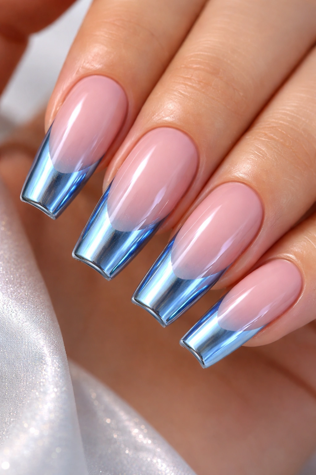 Icy blue chrome tips on a pink base with a glassy reflective finish