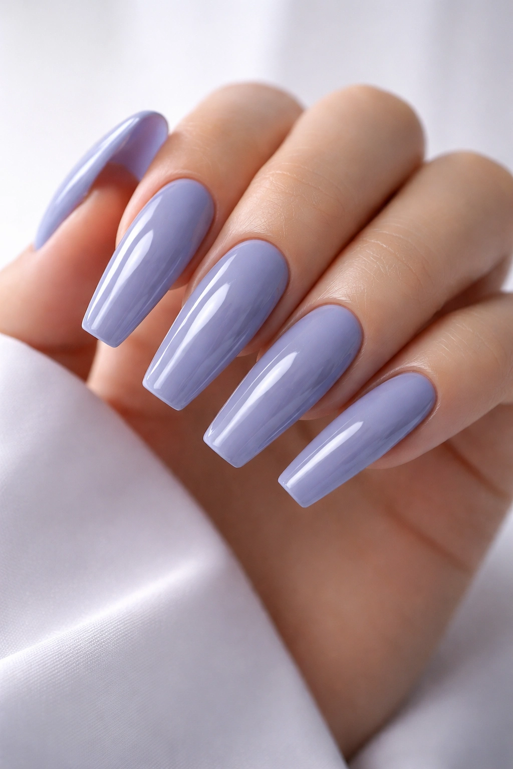 Close-up of icy periwinkle coffin nails with glossy finish