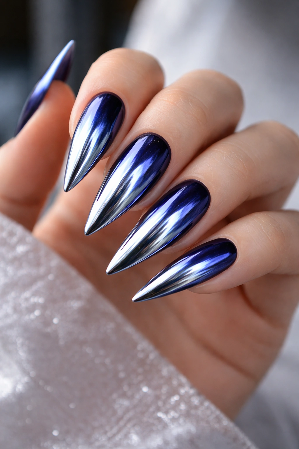 Indigo nails with chrome mirror powder creating a reflective finish