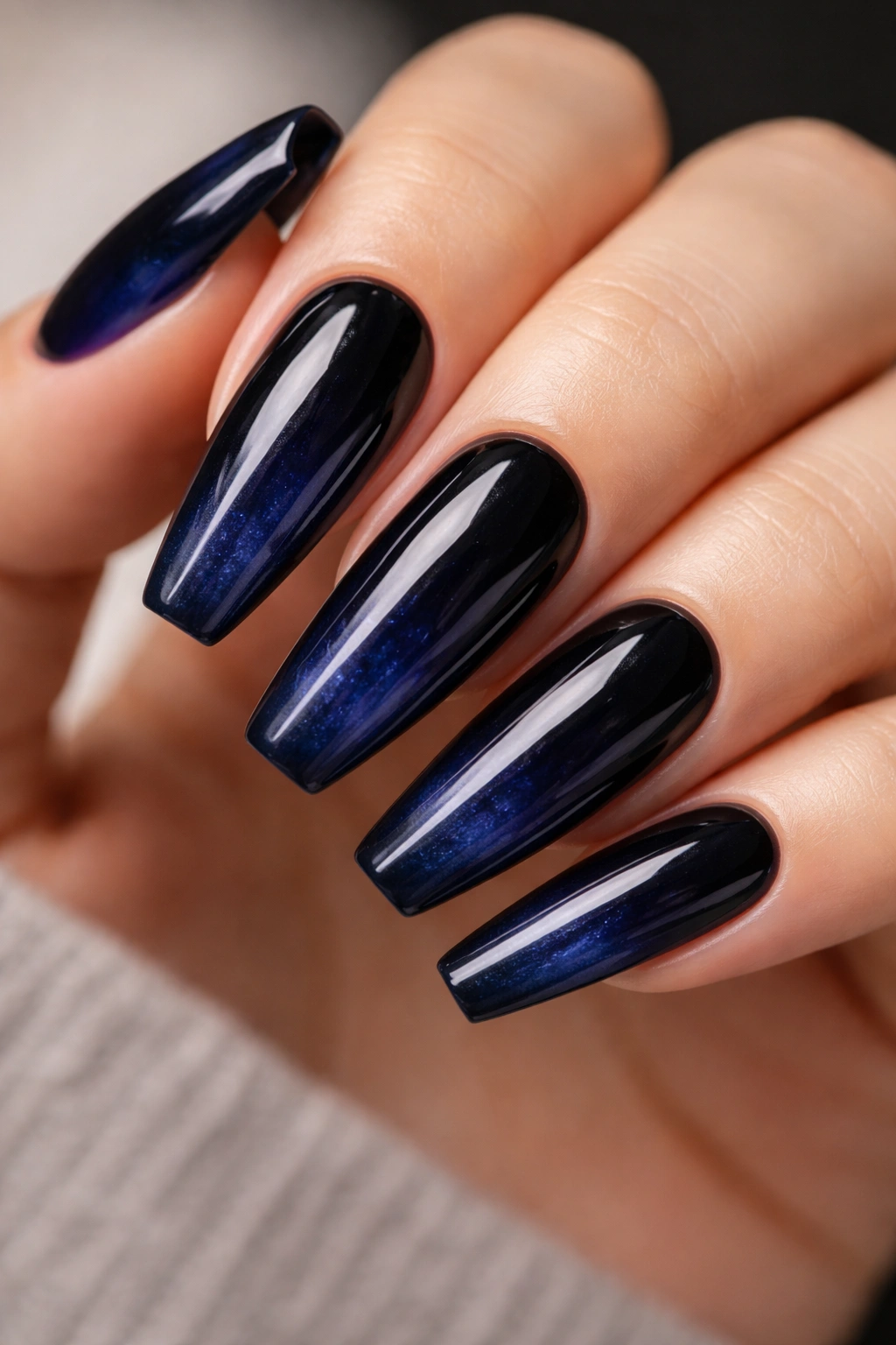 Indigo jelly nails over a black base showing inner glow