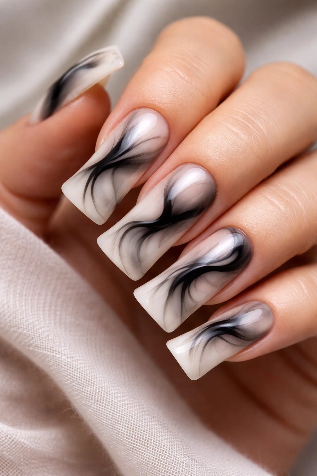 Duck nails with abstract black ink swirl on pale base