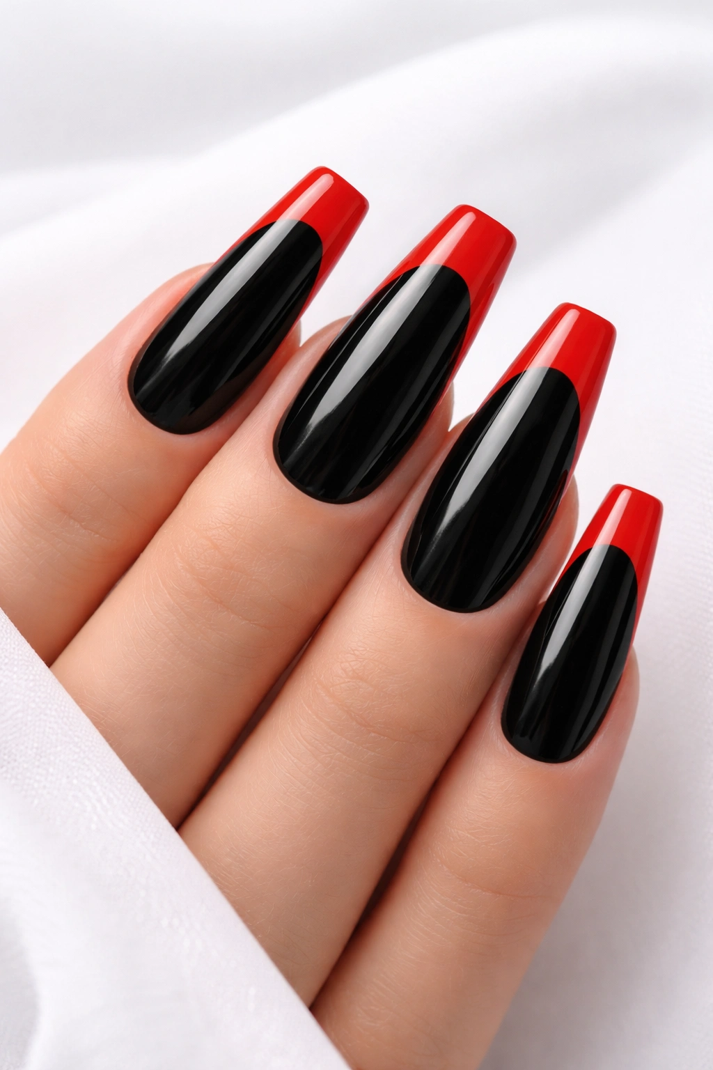 Close-up of inverted French manicure on black nails with red tips