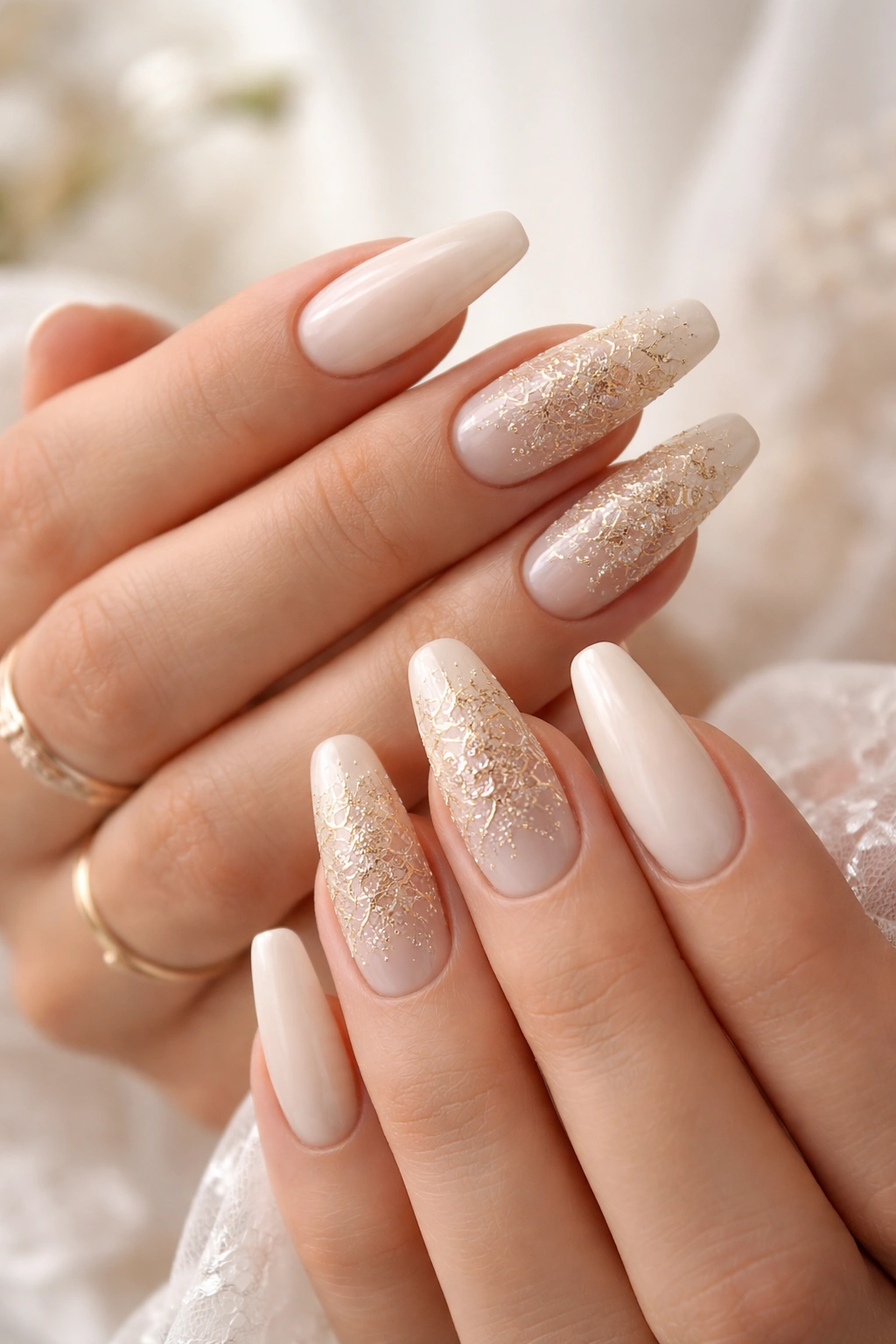 Ivory nails with gold lace detailing on accent nails