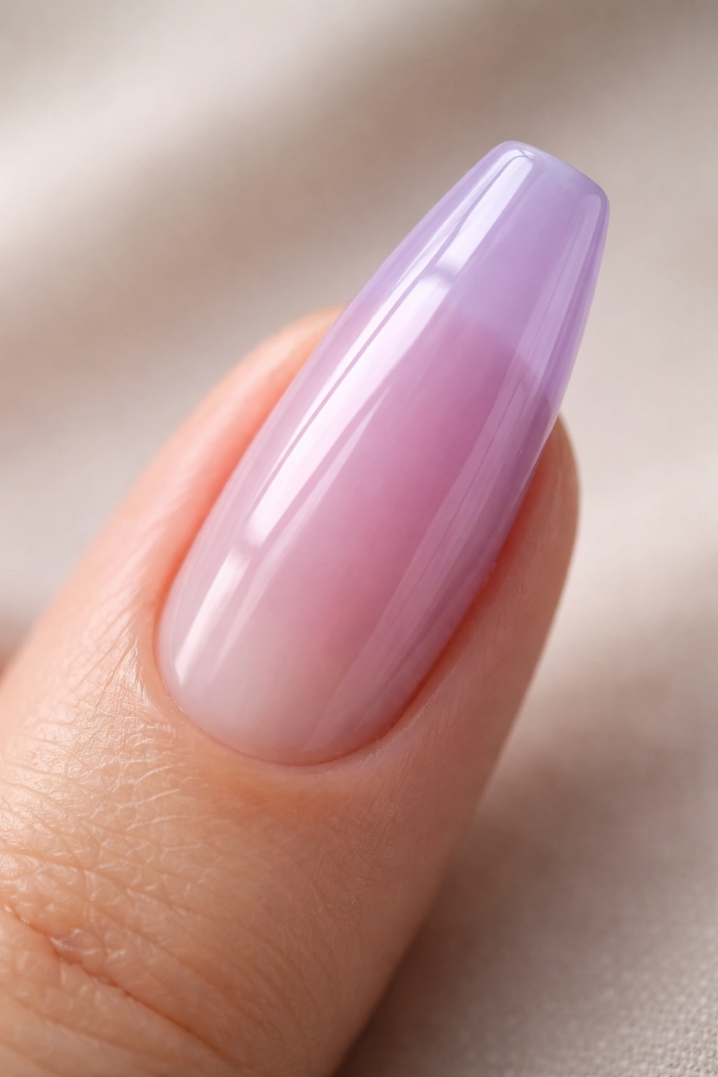 Close-up of a ballerina nail with translucent lilac jelly layer, glassy finish on natural nail