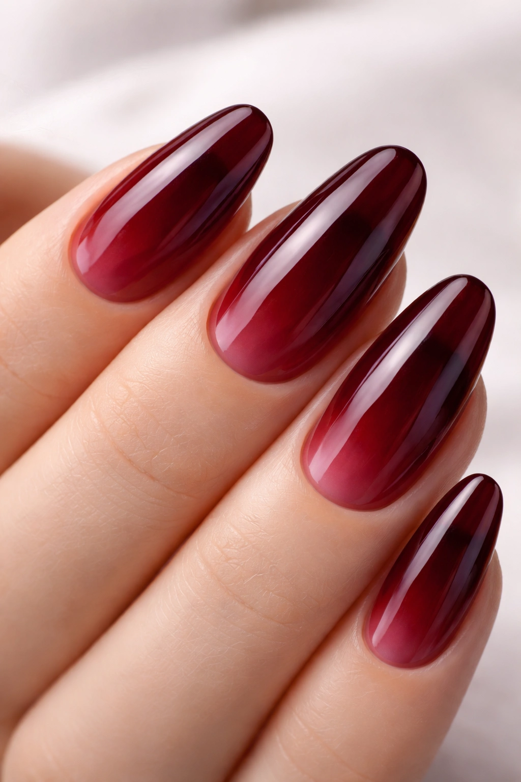 Jelly finish nails showing translucent dark red