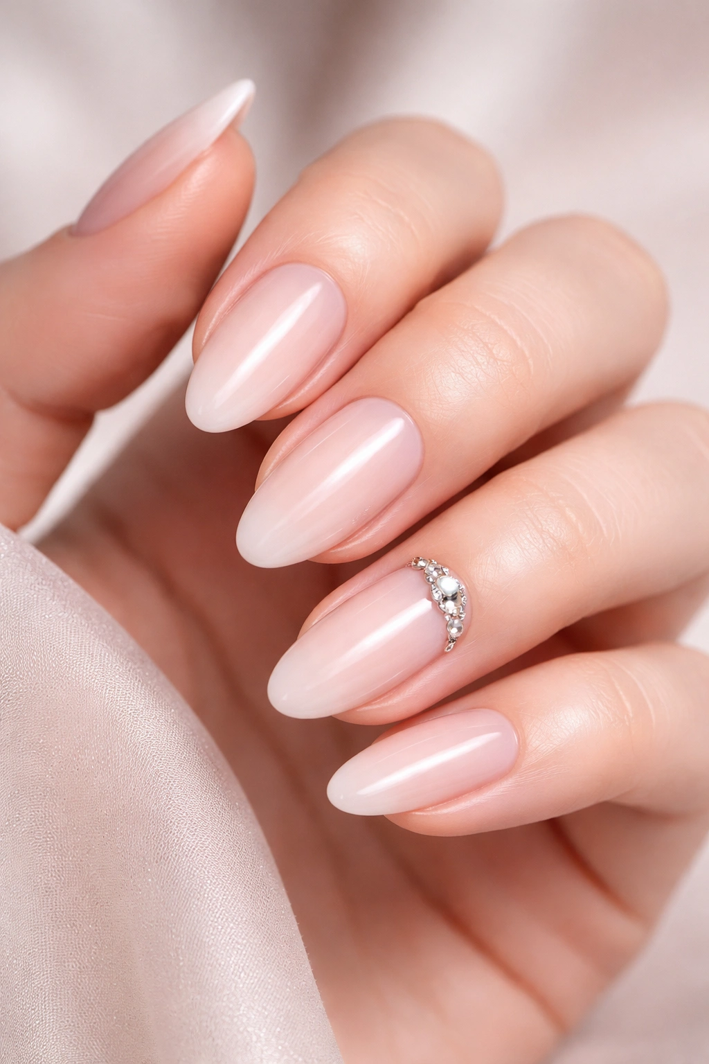 Close-up of nails with a jeweled accent on one nail
