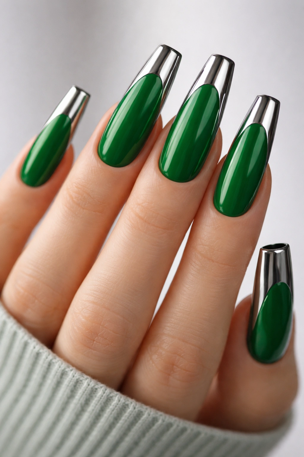 Kelly green coffin nails with chrome tips on a bare hand.