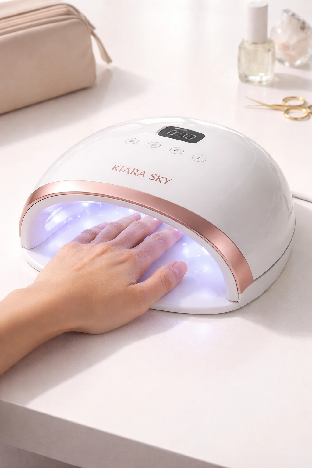 Cordless LED nail lamp with hand under cure in a clean setup.