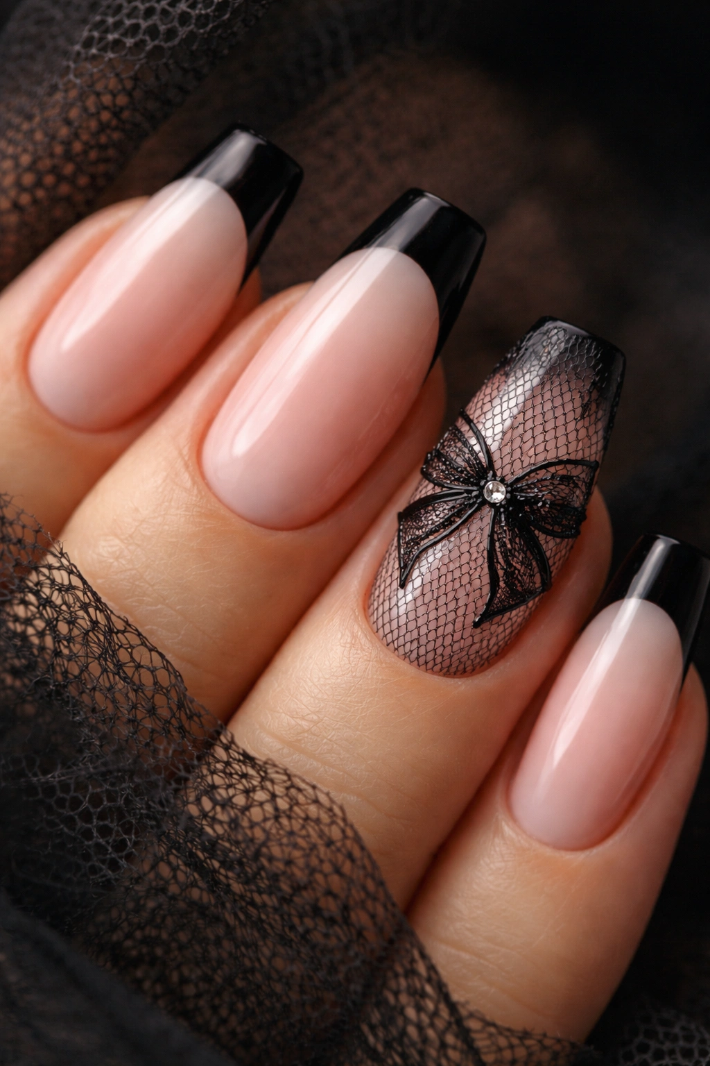 Close-up of blush nails with black lace bow art
