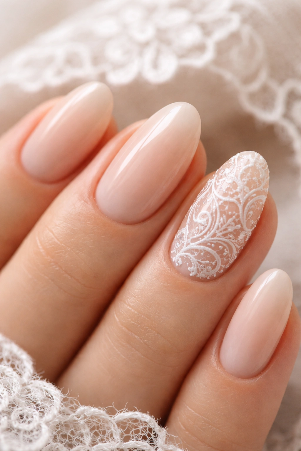 Close-up of lace-inspired nail art on a short almond nail