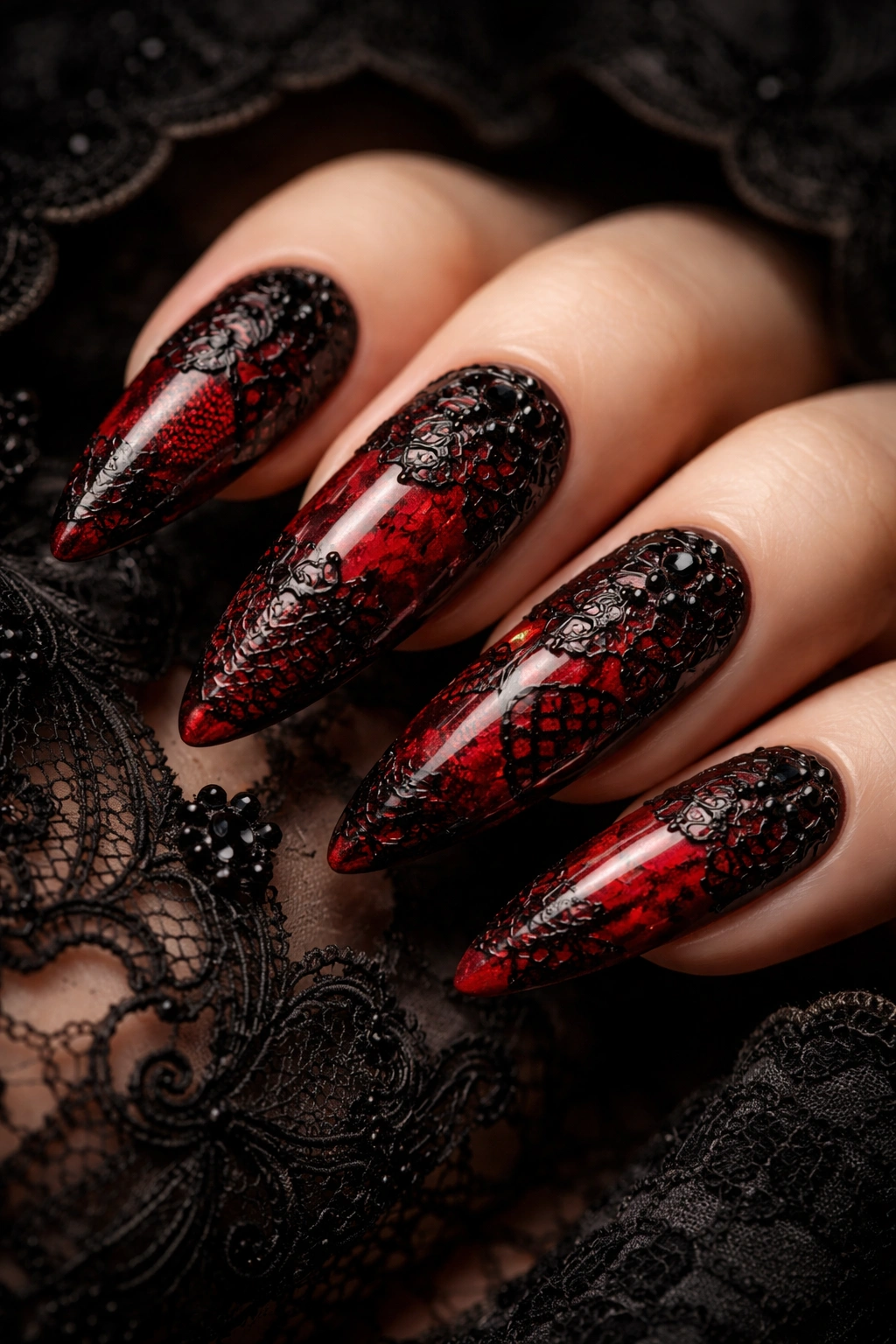 Close-up of nails with black lace pattern over red base