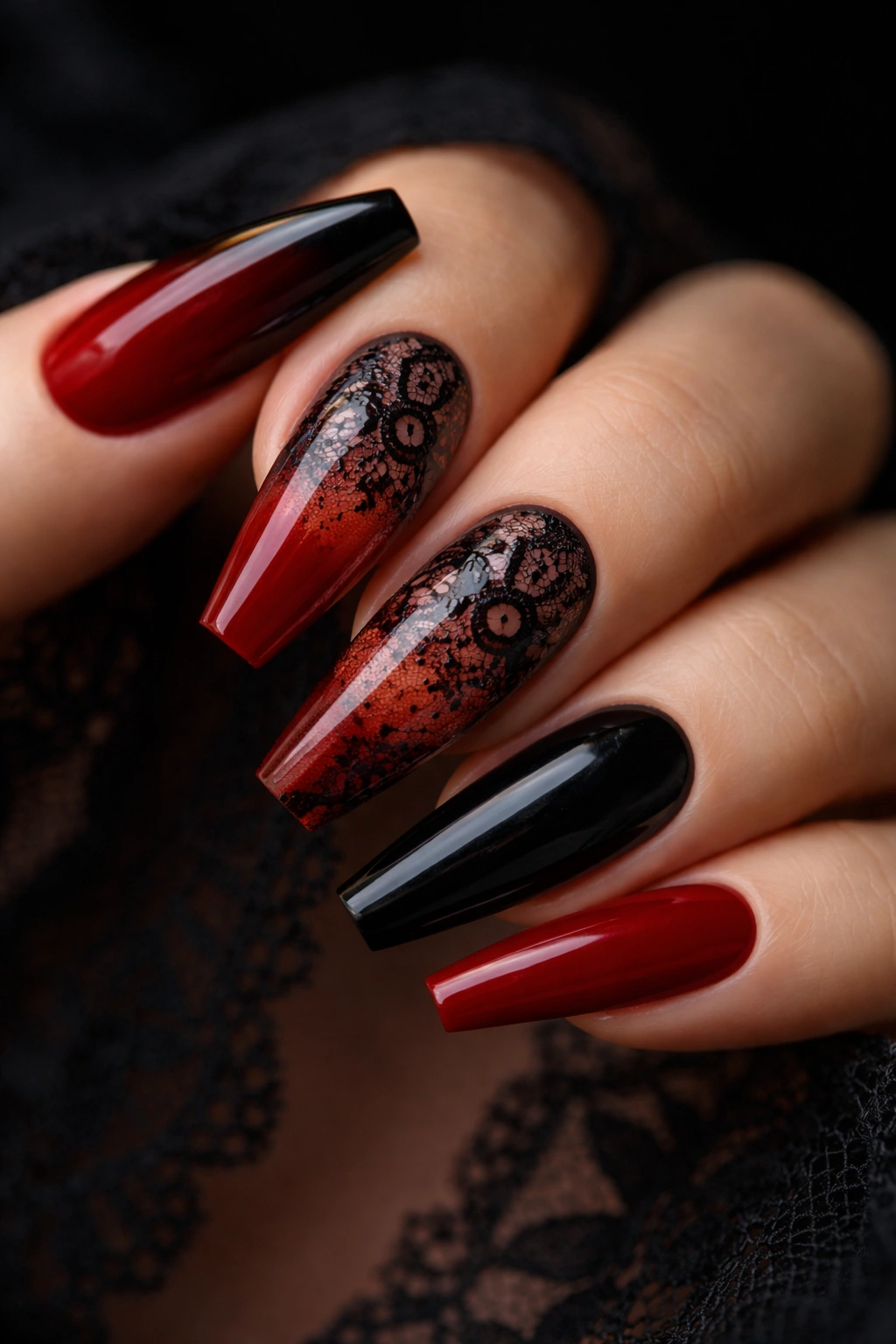 Close-up of nails with sheer red base and black lace overlay on two nails.