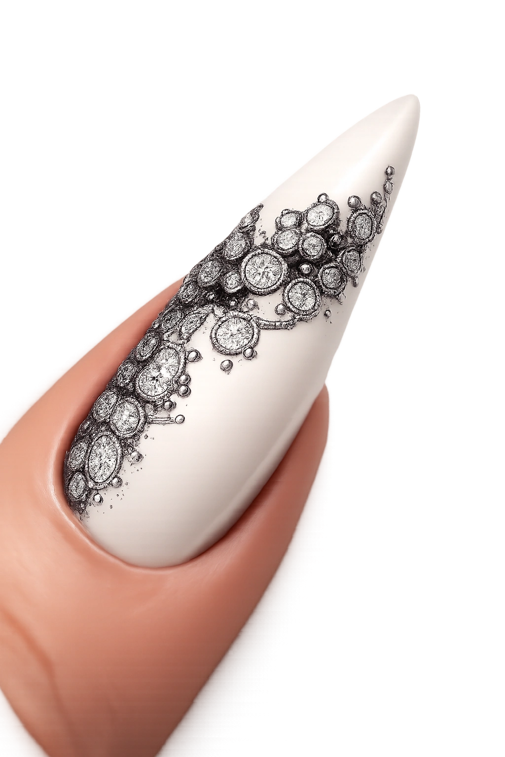 Close-up of a white stiletto nail with delicate black lace filigree pattern