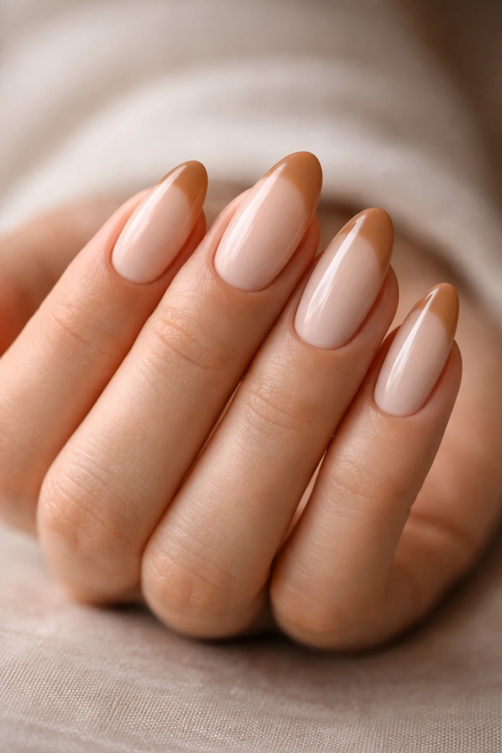 Almond nails with latte French tips on milky neutral base